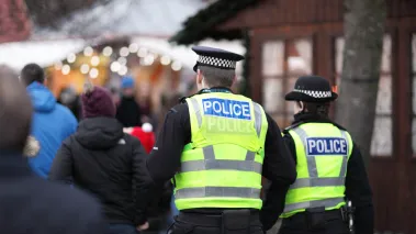 Police in hi-visibility jackets policing crowd control at a UK event